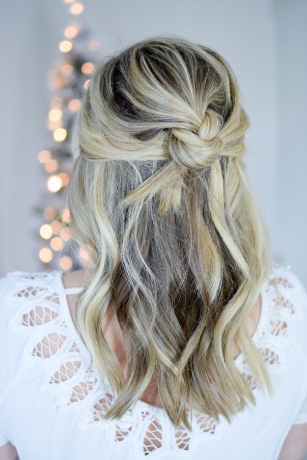 a knotted half updo with a volume on top and some waves down is a beautiful option to realize quickly