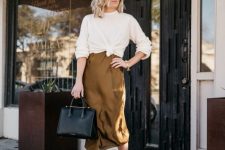 27 a mustard-colored slip midi dress, a white jumper tied up, nude shoes and a black tote for work