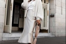 27 a stylish neutral work look with a white t-shirt, a slip mermaid skirt, white trainers, a white chunky cardigan with puff sleeves