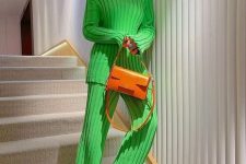 28 a bright winter look with an apple green ribbed jumper and pants, neutral boots, an orange bag and statement earrings
