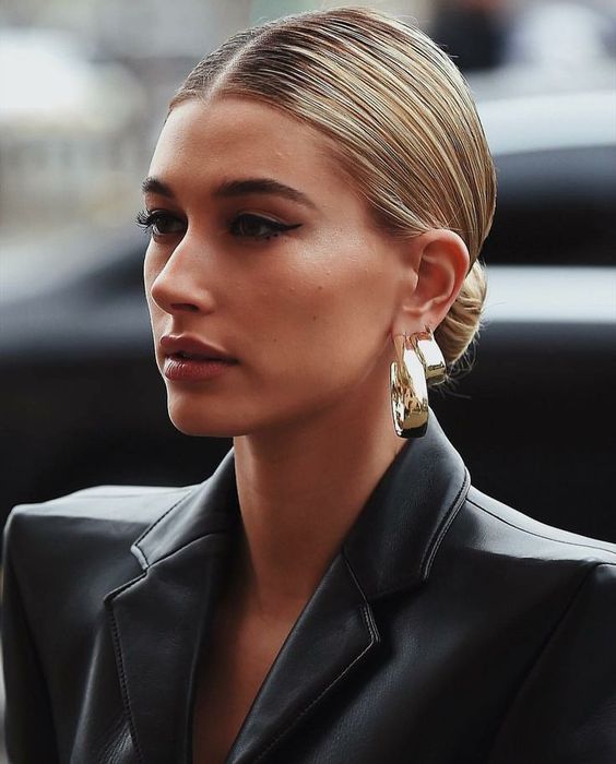 a low bun with a super sleek top paired with statement earrings is a timeless and very refined idea for any party