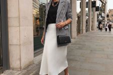 28 a monochromatic work look with a black t-shirt, a white slip midi skirt, white sneakers, a printed black and white blazer and a black bag