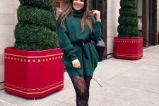 28 an emerald sweater mini dress with long sleeves and a turtleneck, a black belt, black printed tights and boots for the holidays