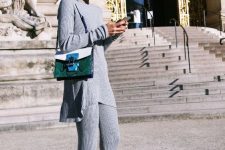 29 a chic winter outfit with a pastel blue flare jumper and flare pants with slits, a two-tone bag