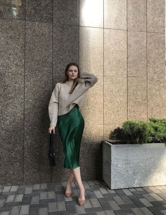 a sophisticated fall work outfit with a neutral sweater, an emerald slip midi, nude shoes and a black bag