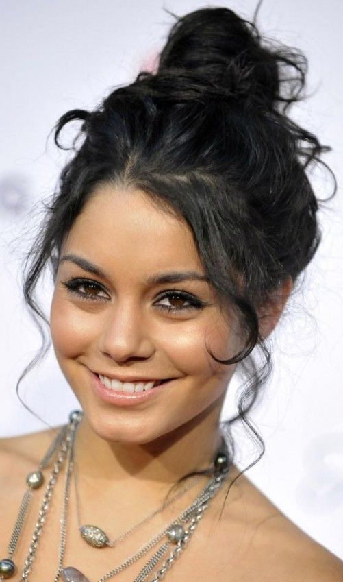 a top knot with curls framing the face and some curls down is a cool idea for an effortlessly chic look