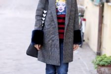 With black and red striped shirt, sunglasses, black leather embellished bag, navy blue flare jeans and black faux fur flat shoes