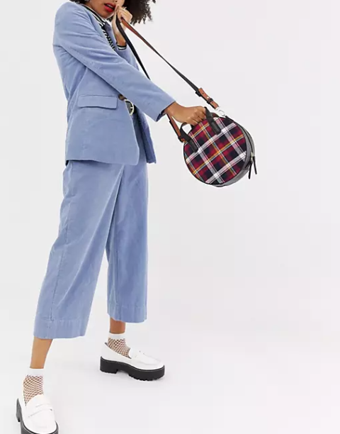 With black and white striped shirt, blue long blazer, blue culottes, white fishnet socks and black and white platform shoes