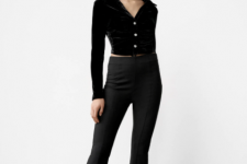 With black high-waisted flare trousers and black leather boots