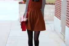 With brown leather bag, black tights and black ankle boots