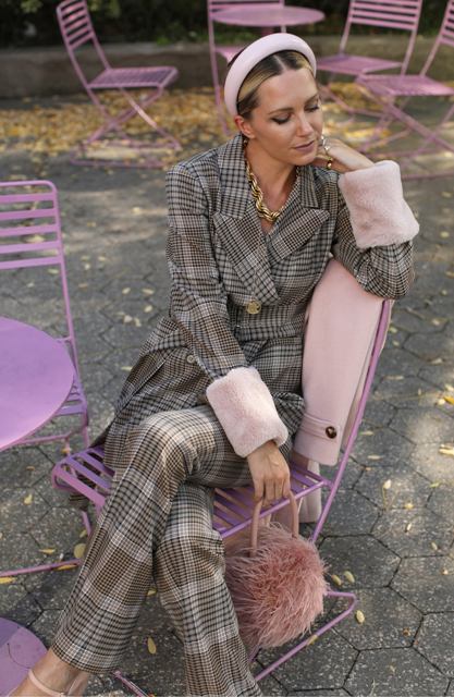 With checked trousers, pale pink feather rounded bag, pale pink ankle strap heeled shoes, golden necklace and pale pink headband