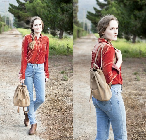 With light blue jeans, brown leather low heeled boots and beige backpack