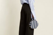With light blue printed ruffled long sleeved shirt, black high-waisted culottes and black heeled shoes