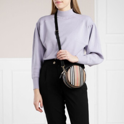 With lilac loose turtleneck and black high waisted pants