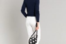 With navy blue and gray sweater, white cropped pants and white lace up flat shoes
