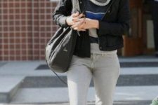 With striped shirt, black bomber jacket, black tote bag, light gray jeans and lace up mid calf boots