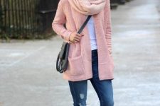 With white t-shirt, pale pink cardigan, gray crossbody bag, distressed skinny jeans, sunglasses and brown lace up ankle boots