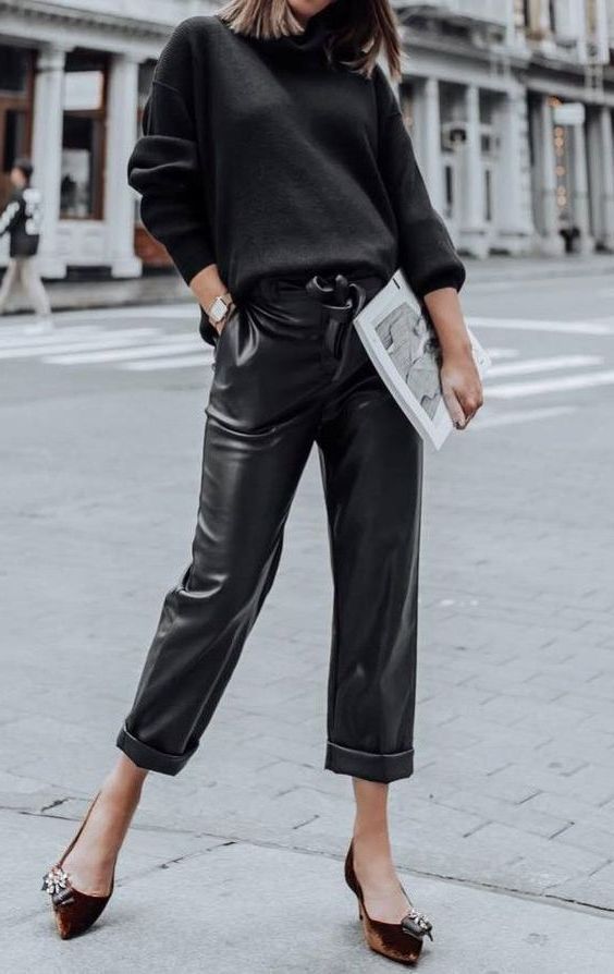 a black jumper, black leather cropped pants, rust colored velvet shoes with embellishments