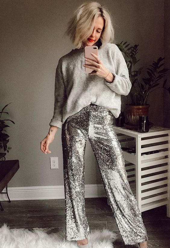 a chic Christmas party look with a grey oversized jumper, silver sequin pants, silver shoes is ultimate