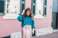 a colorful holiday outfit with a teal oversized sweater, a striped sequin midi and teal strappy shoes just wows