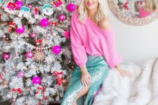 a hot pink off the shoulder jumper, a green sequin midi skirt with a slit and gold glitter shoes for maximal glam