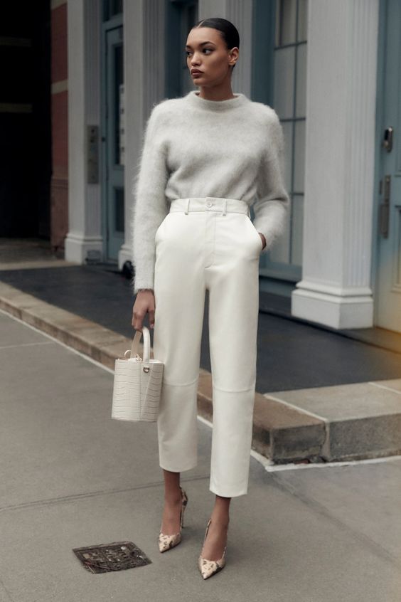 a refined outfit with a grey oversized angora sweater, white high waisted cropped leather pants, printed shoes and a white bucket bag