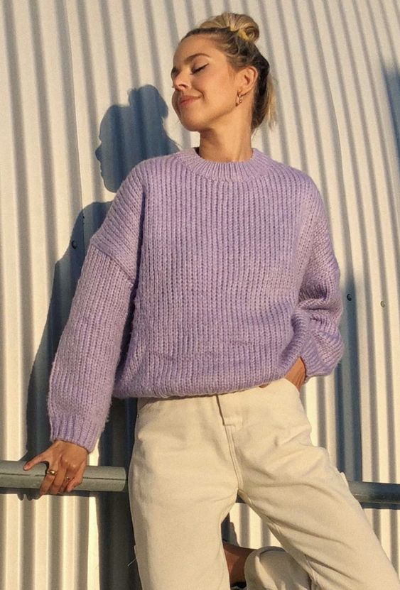 a simple and stylish winter look with a periwinkle chunky knit sweater, tan jeans and hoop earrings