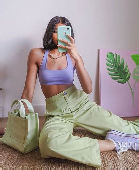 a spring sporty look with a periwinkle crop top and sneakers, mint green pants and a mini bag