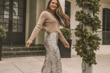 a tan cropped sweater paired with silver sequin flare pants and nude boots for a classy holiday party look