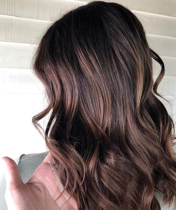 fantastic long and wavy cold brew hair with burgundy and caramel balayage is amazing and super lovely