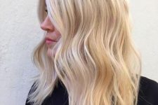 gorgeous creamy londe wavy medium-length hair with icy blonde balayage to make the hair look bolder