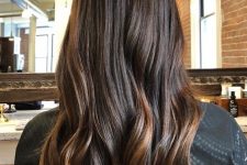 long and a bit wavy cold brew hair with a bit of honey and caramel balayage on the tips and in the lower part looks trendy and chic