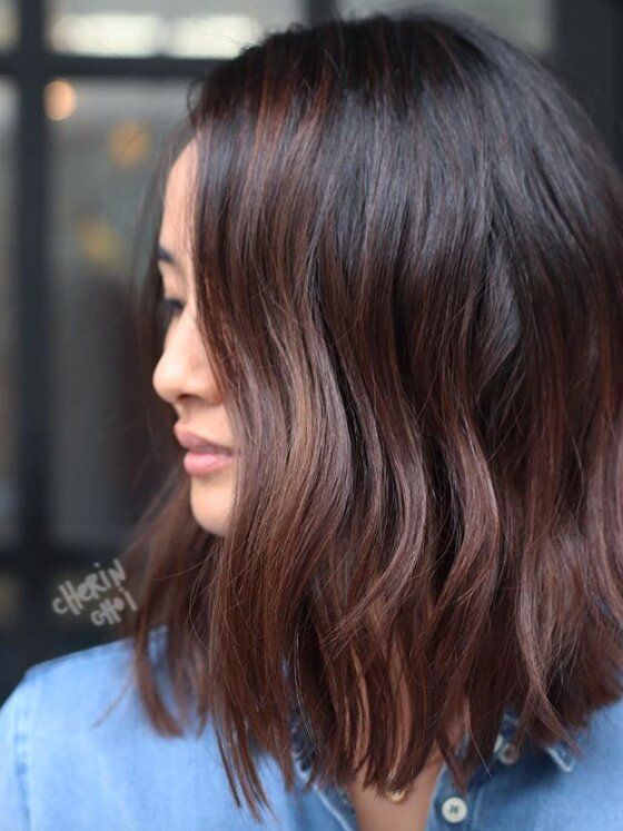 wavy and textural cold brew hair with burgundy touches and tips for a more dimensional and bold look