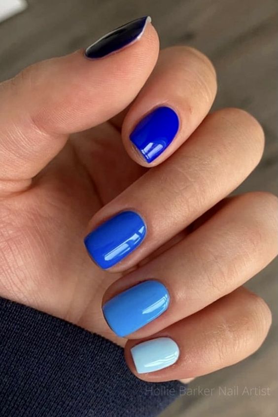 a colorful manicure done in different shades of blue is a great way to show off two trends in one