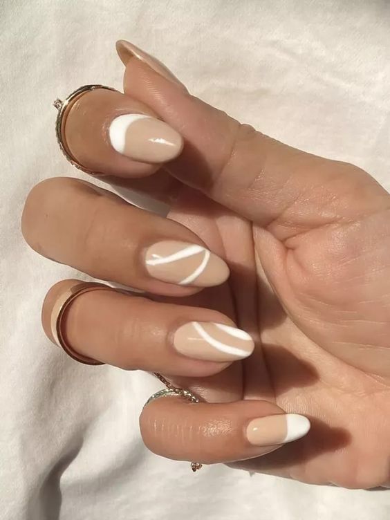 tan and white abstract pattern nails are amazing to make your look super trendy this year