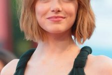 Emma Stone with a short textural bob and bottleneck bangs for a catchier and bolder look