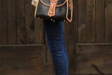 With beige and black geometric printed cardigan, black and brown leather bag and navy blue jeans