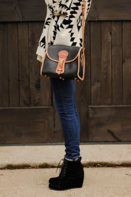 With beige and black geometric printed cardigan, black and brown leather bag and navy blue jeans