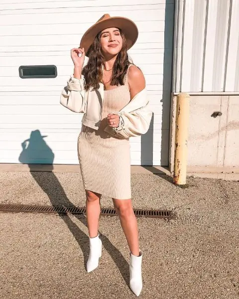 With beige sleeveless knee-length dress, beige crop jacket and white high heel boots