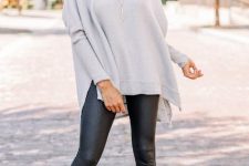 With black leather leggings and beige heeled shoes