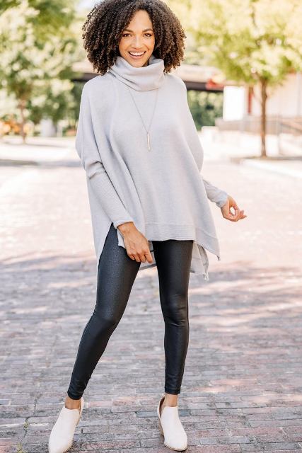With black leather leggings and beige heeled shoes