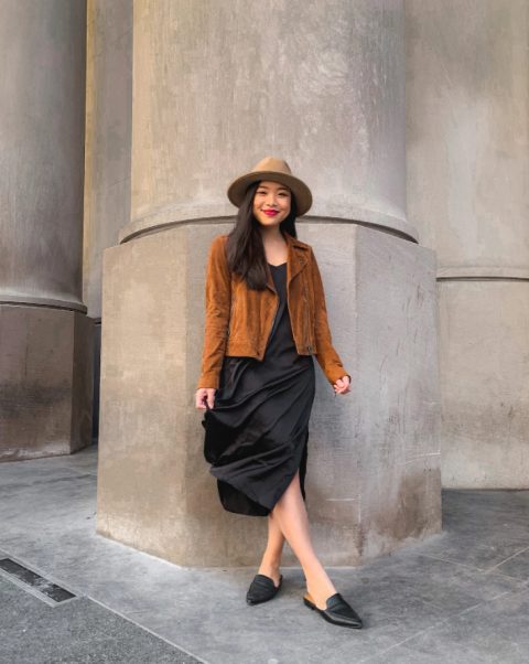 With black satin midi dress, brown suede jacket and black flat mules