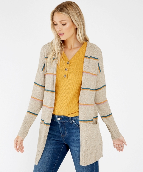 With mustard yellow V-neck sweater and navy blue jeans