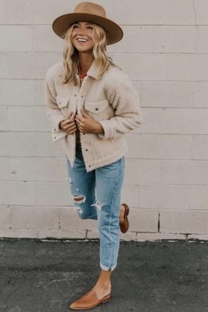 With t-shirt, beige jacket, distressed cuffed jeans and brown flat mules