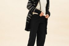 With white knitted sweater, black cropped pants and leather mid calf flat boots