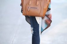 With white long shirt, colorful printed oversized scarf, distressed cuffed jeans, brown leather tote bag and golden bracelets