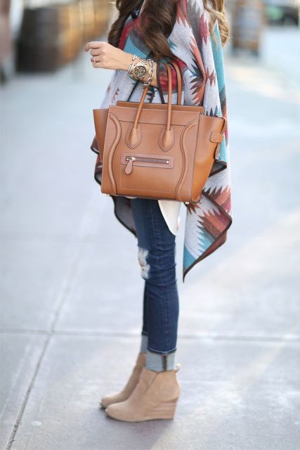 With white long shirt, colorful printed oversized scarf, distressed cuffed jeans, brown leather tote bag and golden bracelets