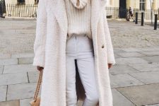 With white pants, white midi coat, sunglasses, beige chain strap bag and black and beige shoes
