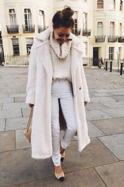 With white pants, white midi coat, sunglasses, beige chain strap bag and black and beige shoes
