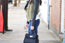 With white shirt, black and olive green leather sleeved crop jacket, sunglasses, black tweed bag and navy blue skinny jeans